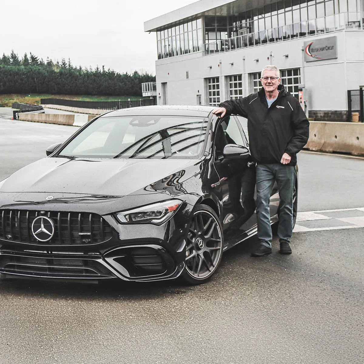 Vancouver Island Motorsport Circuit instructor Ross Bentley standing beside a Mercedes-Benz 2026 CLA 35 AMG.